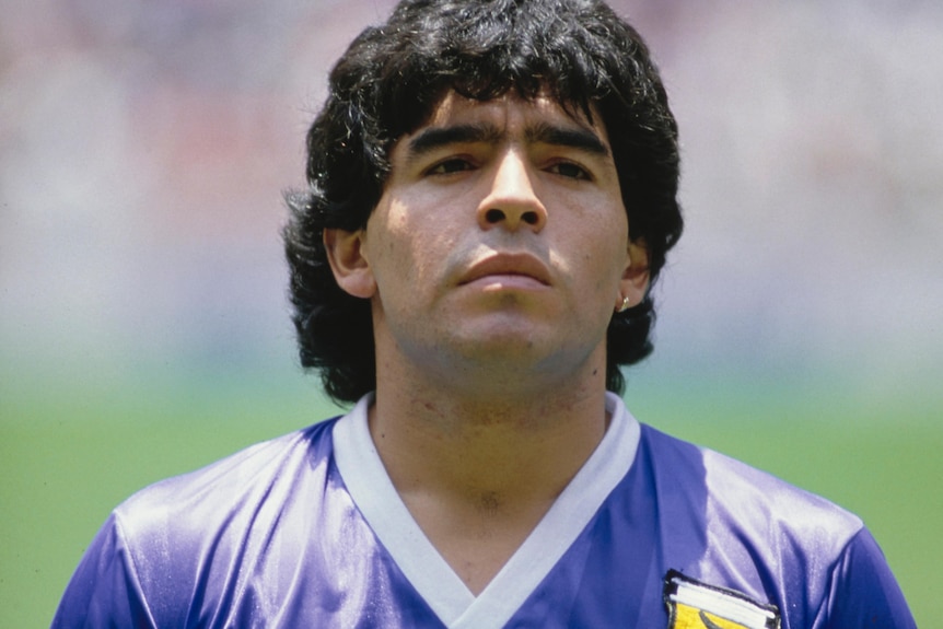 Diego Maradona stands to attention