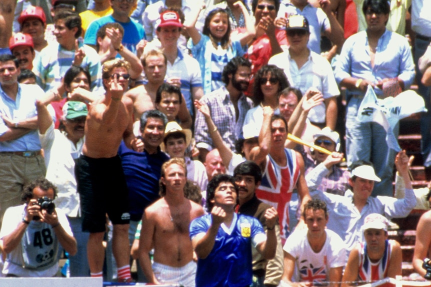 Fans gesture at Diego Maradona