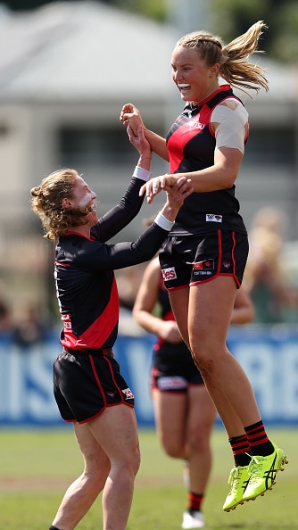 Emily Gough celebrating with teammates after a goal.
