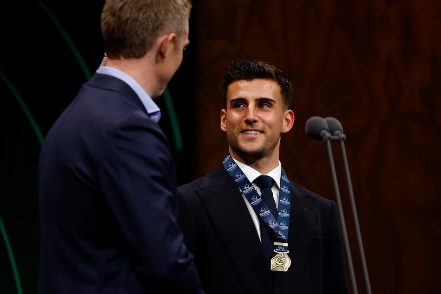 Nick Daicos smiles while speaking after winning a medal