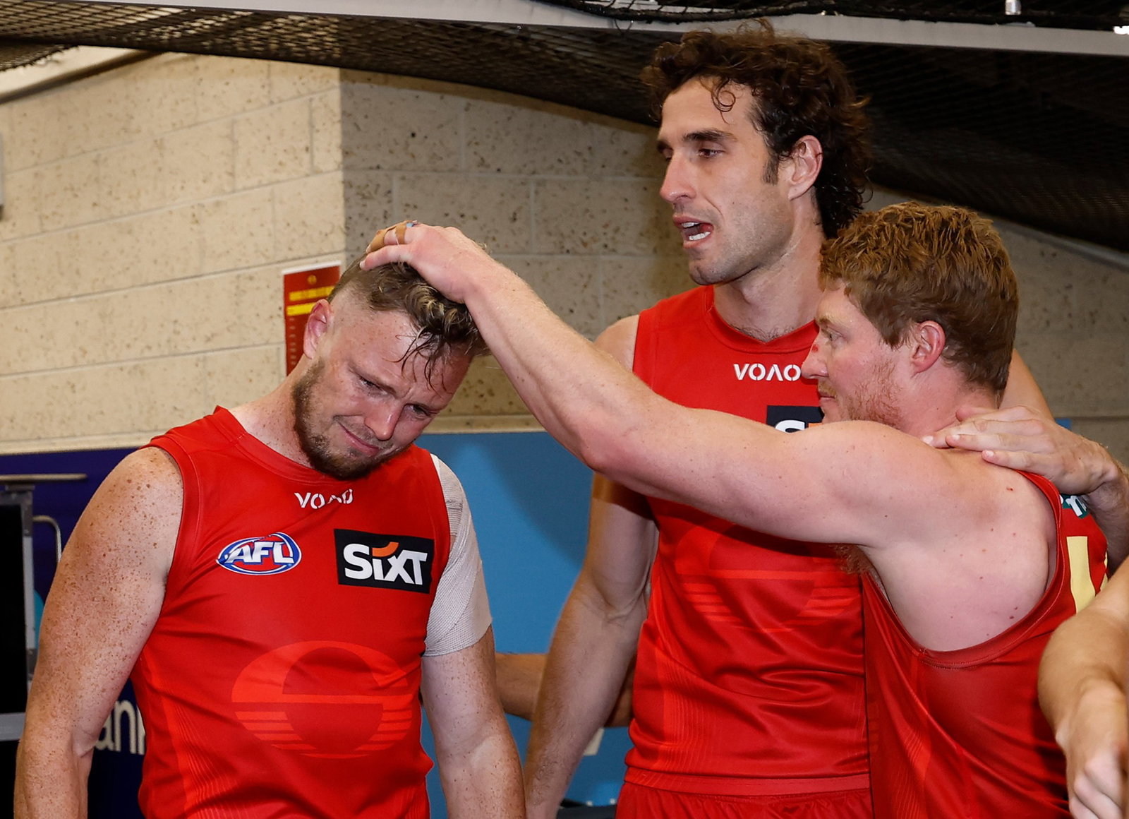 Nick Holman of the Suns is consoled by teammate Matt Rowell after his final match during the 2026 AFL Round 24 match between the St Kilda Saints and the Gold Coast Suns at Docklands on August 20, 2026 in Melbourne, Australia.