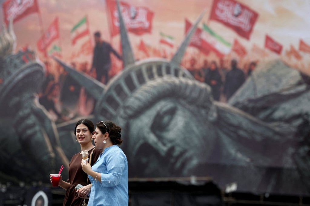 People walk past an anti-US hoarding in Tehran, Iran, on Monday. Photo: WANA via Reuters People walk past an anti-US hoarding in Tehran, Iran, on Monday. Photo: WANA via Reuters