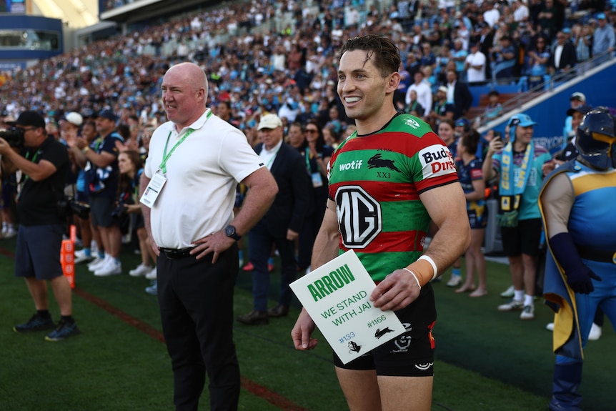 A man waits to be subbed on during a rugby league match