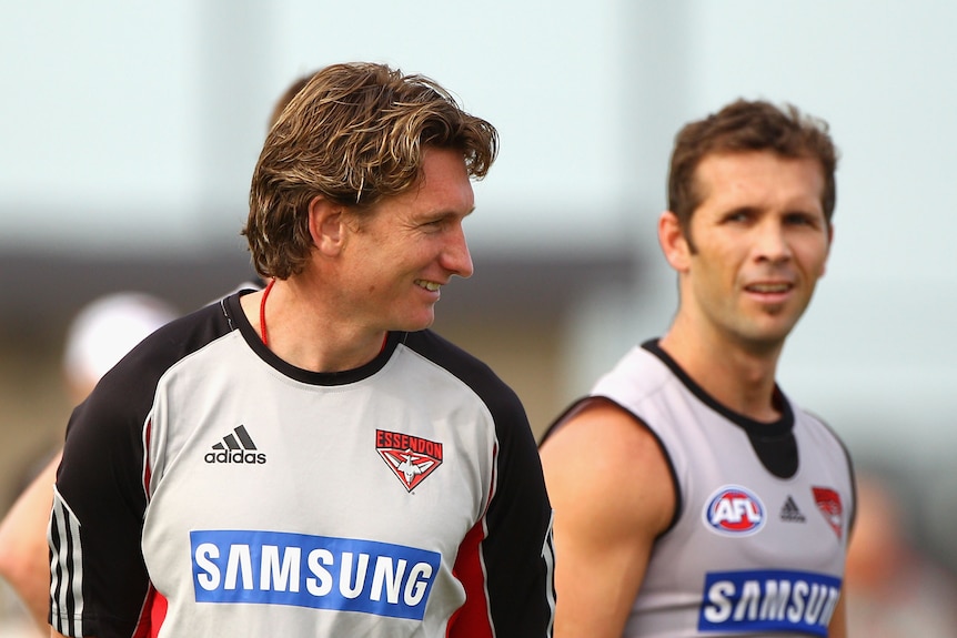 Two men speak during a training session.