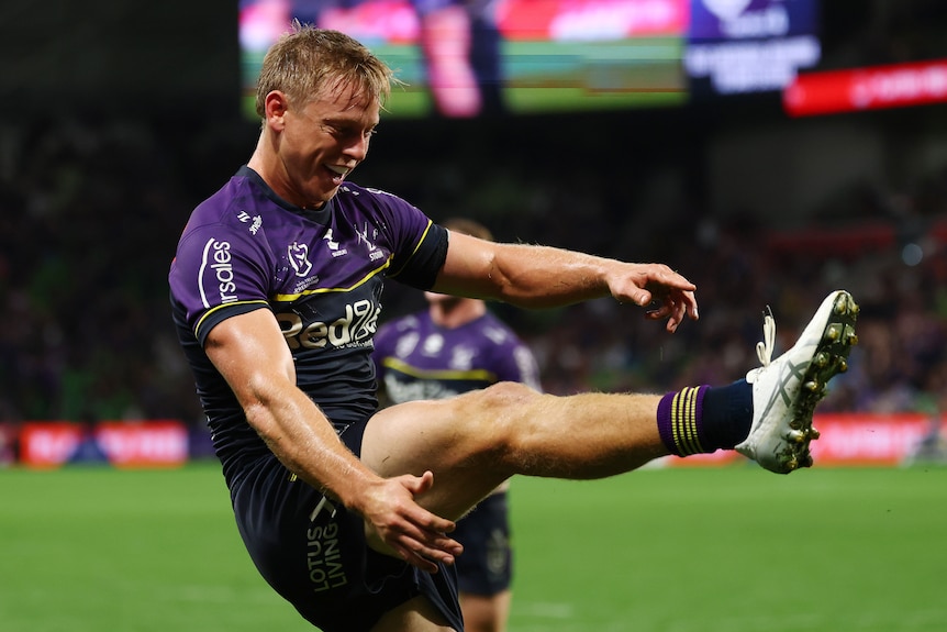 A male rugby player with one leg horizontal as if kicking.