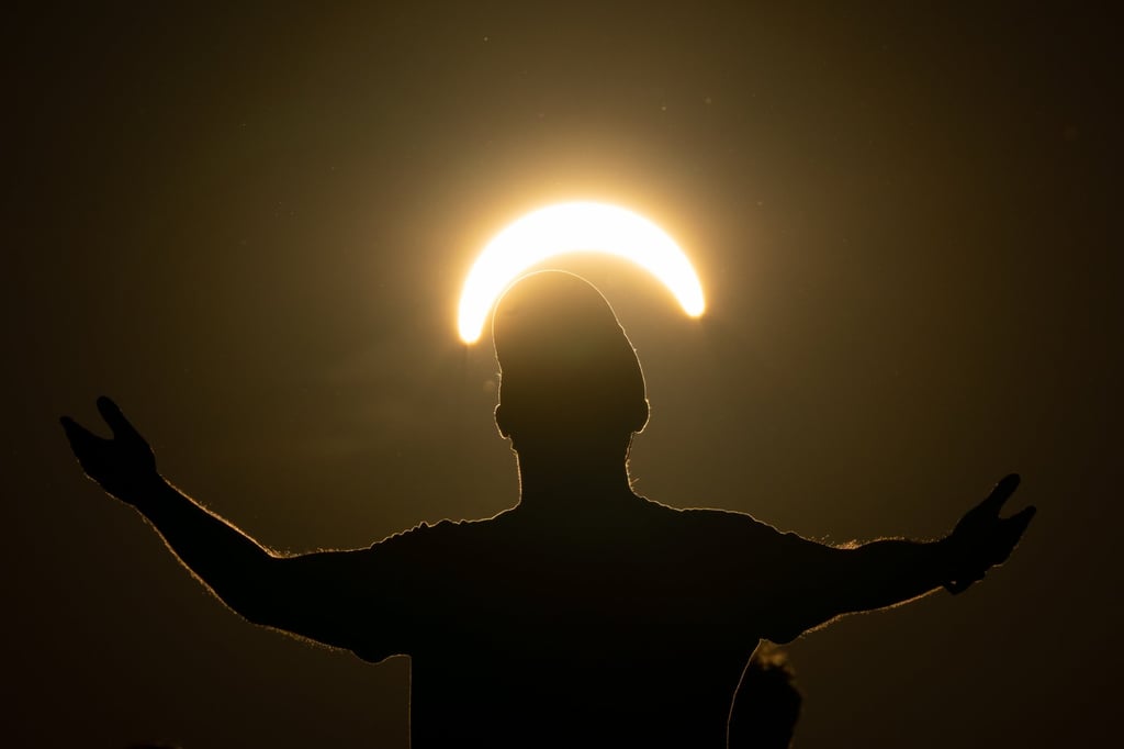 A man dances during a partial solar eclipse on top of Great Feldberg mountain northwest of Frankfurt, Germany, on Wednesday. Photo: EPA A man dances during a partial solar eclipse on top of Great Feldberg mountain northwest of Frankfurt, Germany, on Wednesday. Photo: EPA