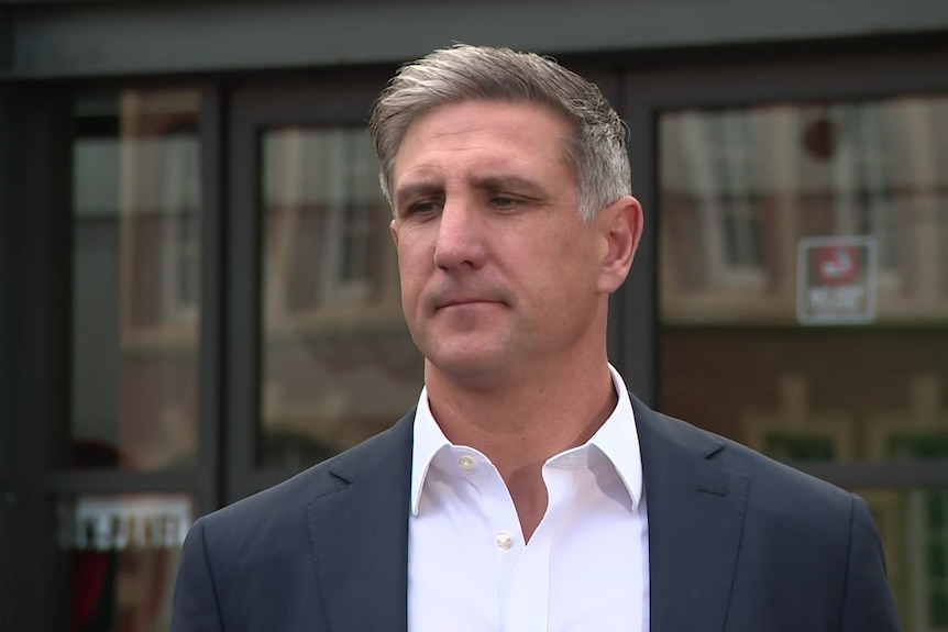 Matthew Pavlich, a man with silver hair in a blue blazer and white collared shirt.