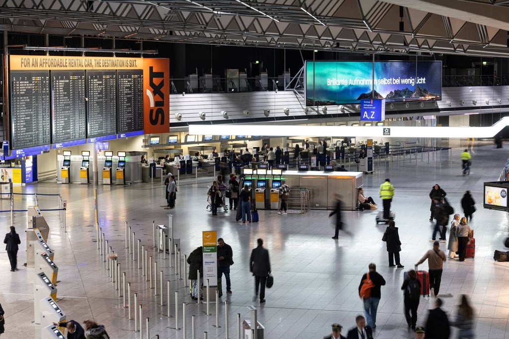 People walk through the departure hall at Frankfurt Airport in February. Photo: dpa People walk through the departure hall at Frankfurt Airport in February. Photo: dpa