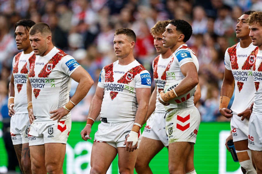 NRL players waiting behind the goal-lne for the opposition to attempt a conversion