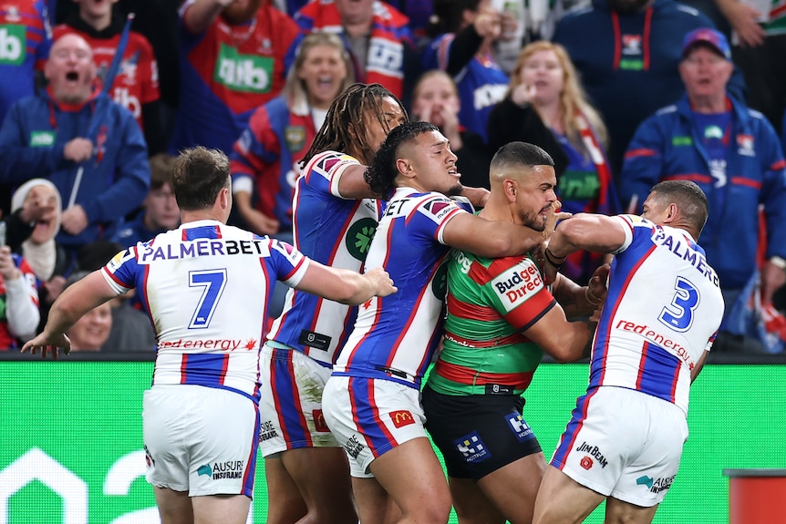 A group of rugby league players fight