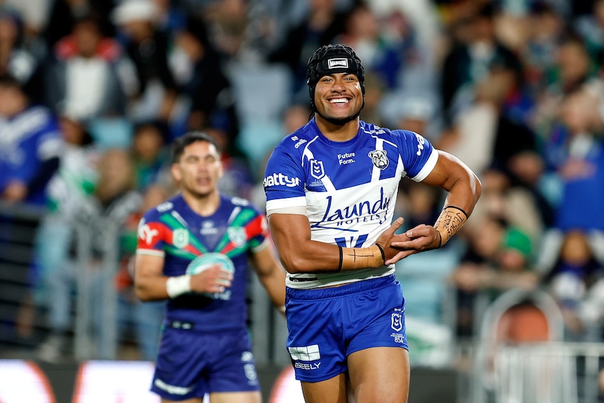 A man celebrates after scoring an NRL try