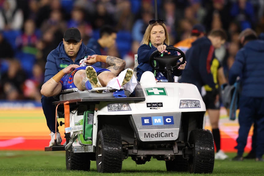 A man is taken from the field after suffering an injury in an NRL match