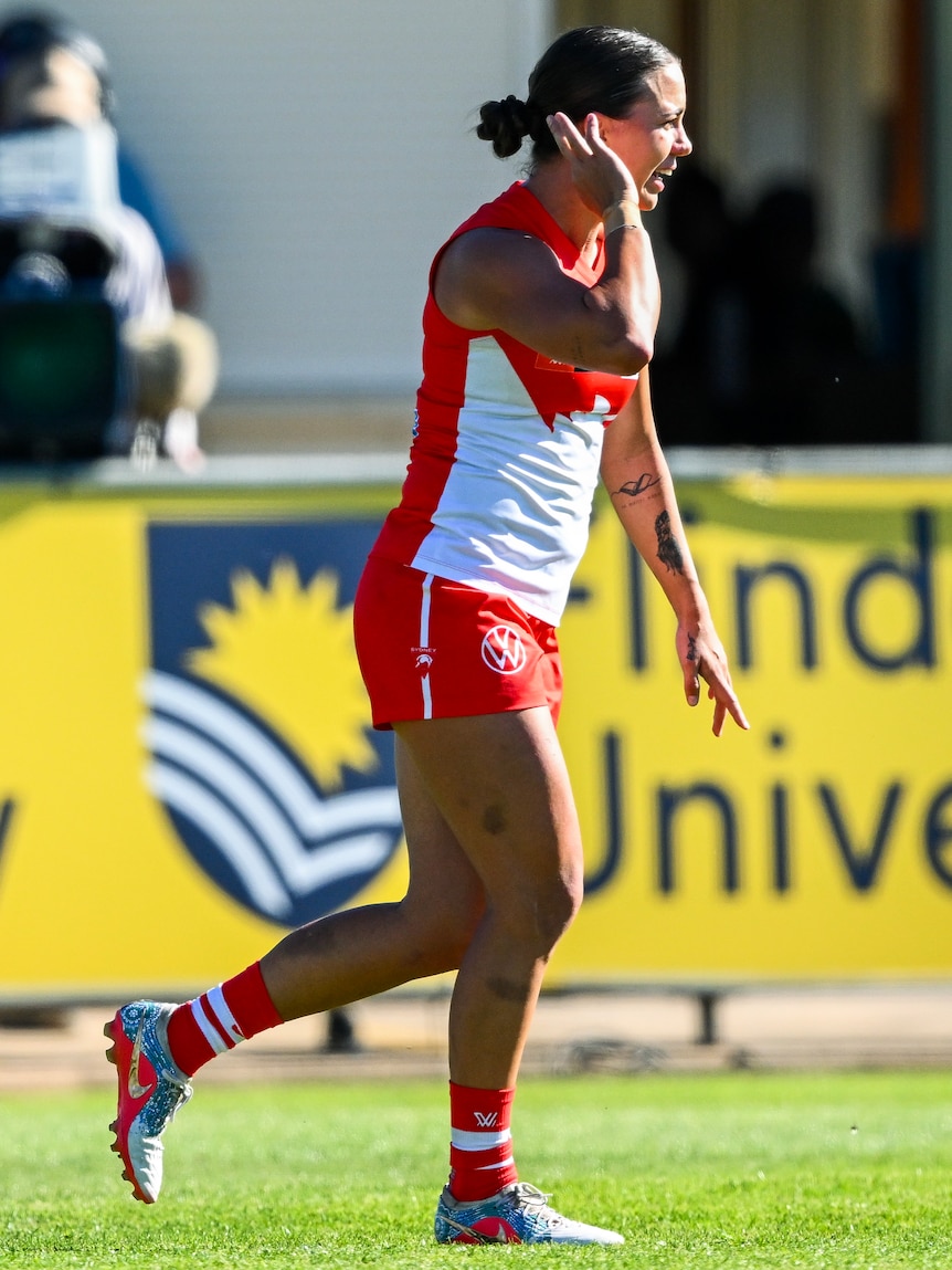 Chloe Molloy celebrates an AFLW goal for the Swans.