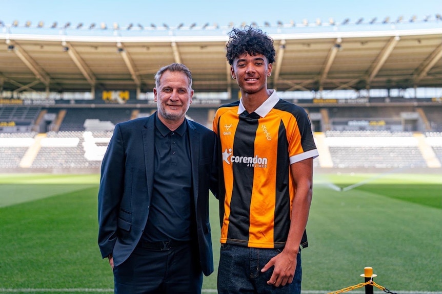 Football manager Buddy Farah with Australian Lucas Herrington posing in a stadium