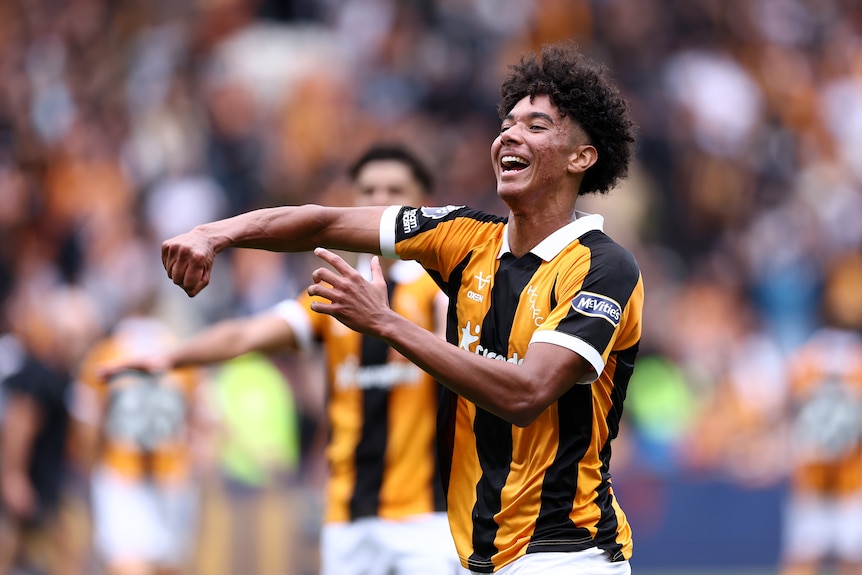 A football player punches the air in celebration.
