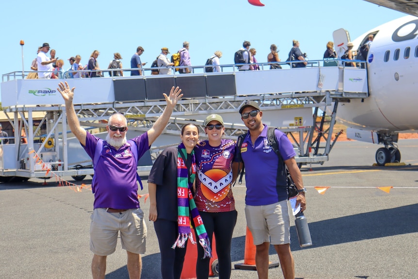 Dockers fans pose on the tarmac of Broome airport
