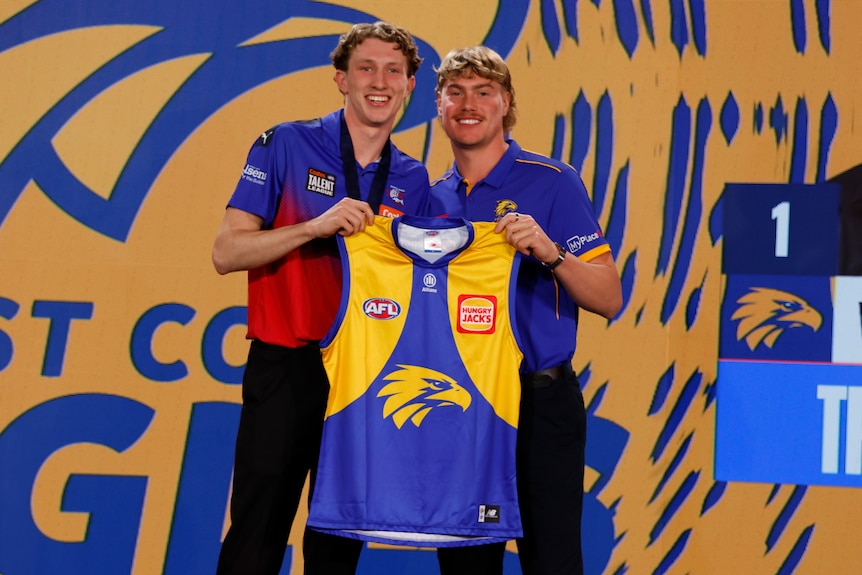 Willem Duursma and Harley Reid pose with a West Coast Eagles guernsey at the draft