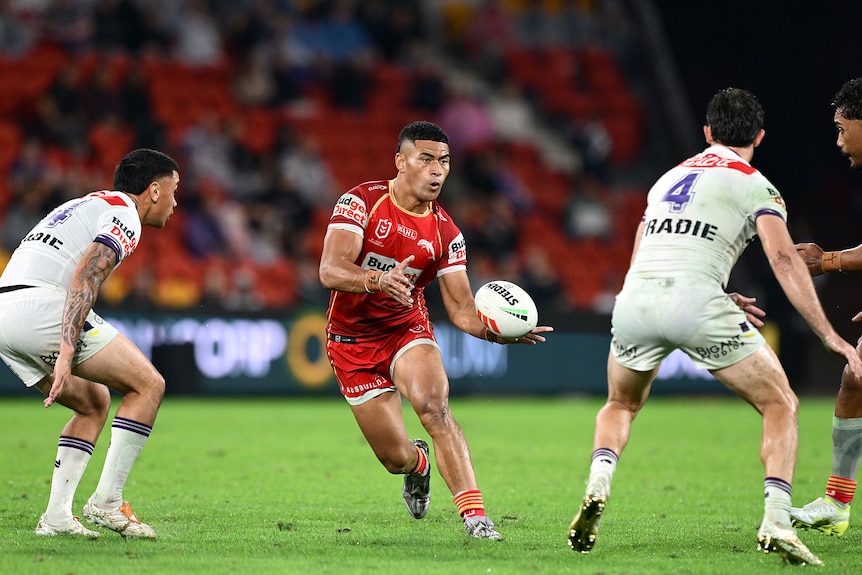 A man runs the ball during a rugby league match 