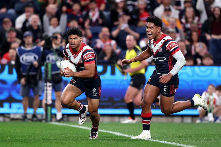 A man goes in to score a try in an NRL match 