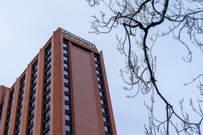 A multi-storey brick building on a partly cloudy day.