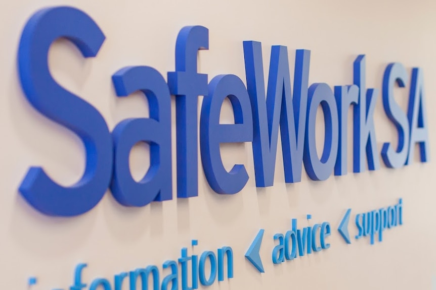 SafeWork SA sign on a wall.