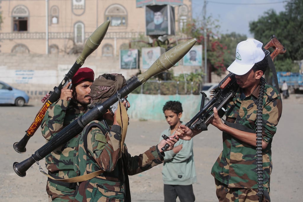 Houthi rebels chat as they check their weapons during a mobilisation campaign in Sanaa, Yemen, on Thursday. Photo: AP