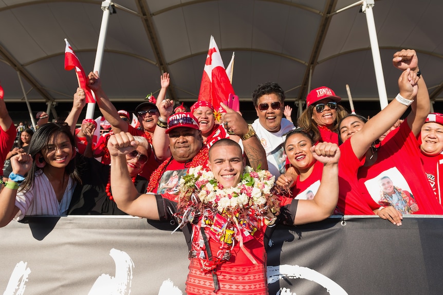 Tui Lolohea celebrates with fans after a match.