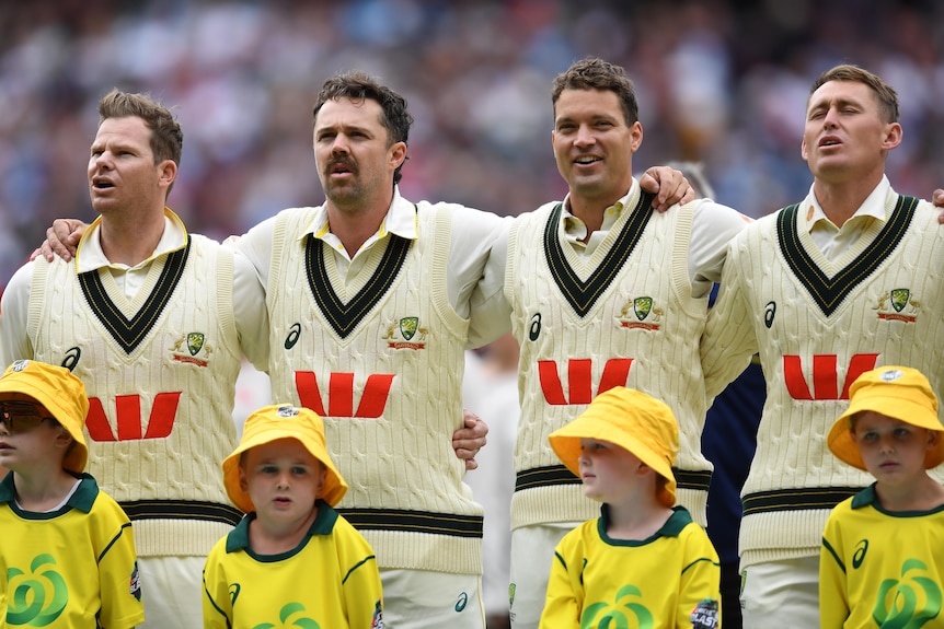Four Australian cricketers sing national anthem together as kids stand in front of them