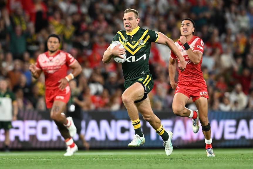 Australia's Tom Trbojevic runs away to score a try in a rugby league Test against Tonga.