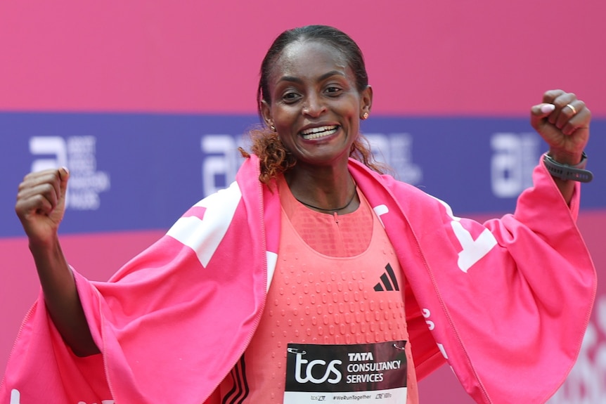 Tigst Assefa holds up her hands