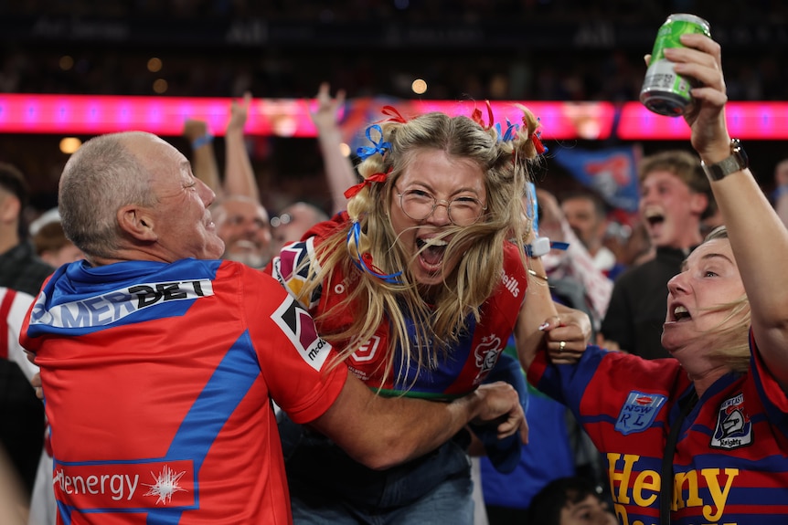 Knights fans celebrate a try in the NRL grand final 