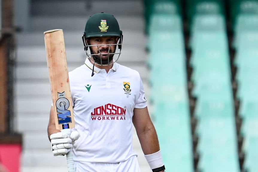 Aiden Markram raises his bat after reaching a half-century against Australia.