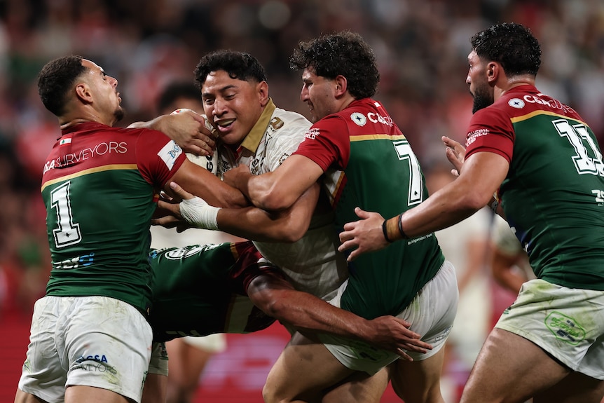 Jason Taumalolo runs with the ball during a rugby league match.