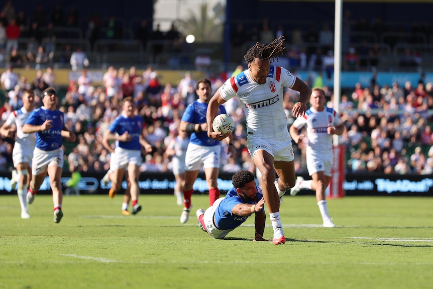 Dom Young runs the ball for England during a Test match.