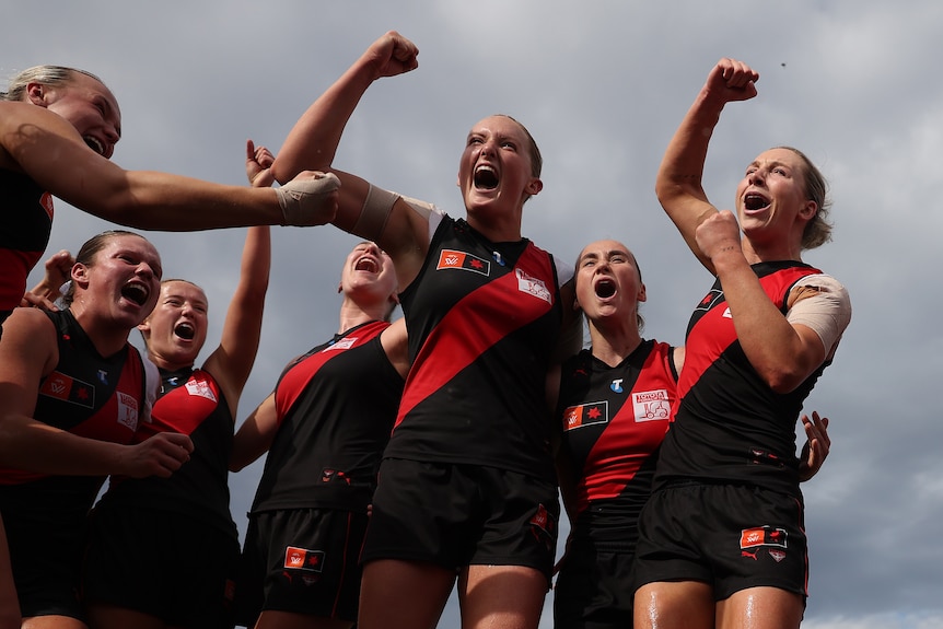 Essendon players celebrate.