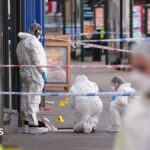 Suspects hunted after police officer injured in shooting