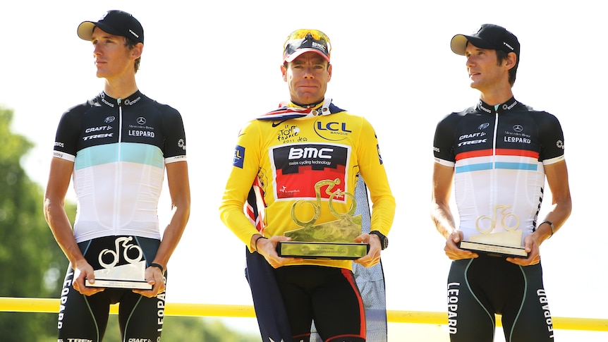 Australia's Cadel Evans on the podium in Paris with two other cyclists after he wins the Tour de France.